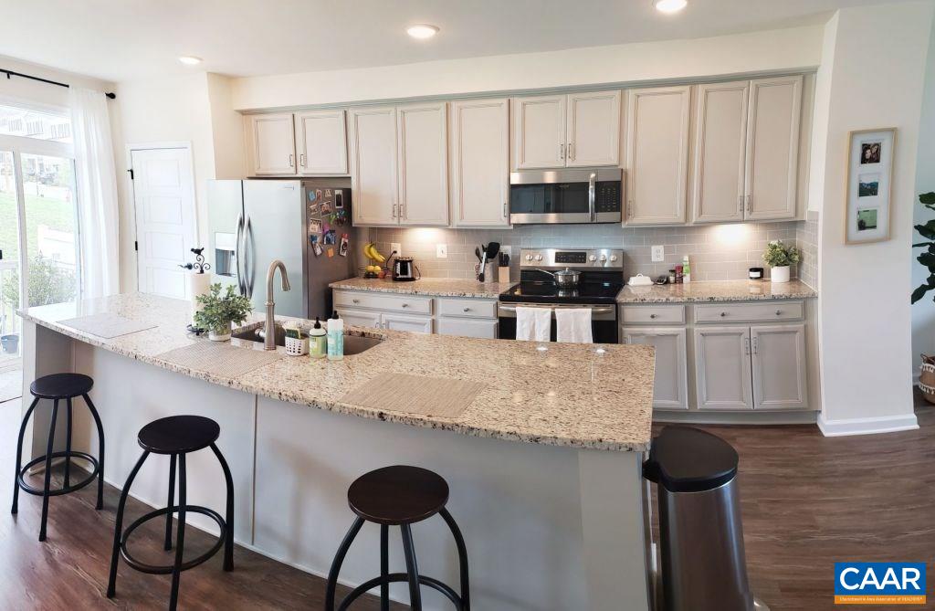 2180 Avinity Loop Charlottesville, VA 22902 - Photo 10 of 32 a kitchen with stainless steel appliances granite countertop white cabinets a sink and a stove