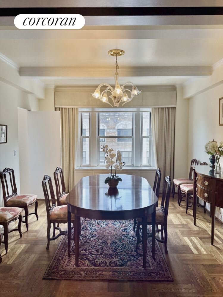 135 East 74th Street, Unit 11BC Manhattan, NY 10021 - Photo 5 of 13 a dining room with furniture a rug and a chandelier