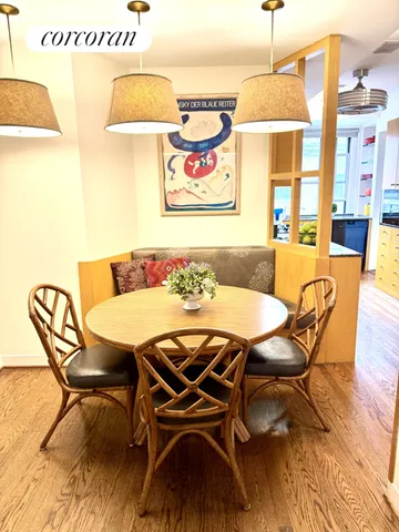 a kitchen with stainless steel appliances kitchen island granite countertop a table and chairs in it