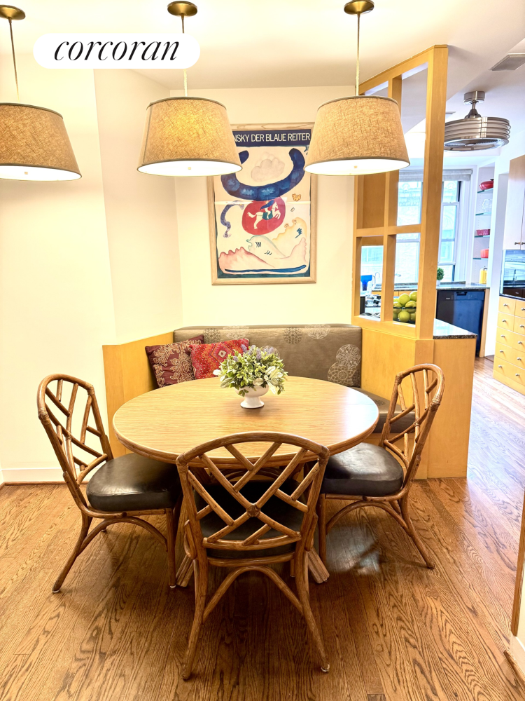 135 East 74th Street, Unit 11BC Manhattan, NY 10021 - Photo 7 of 13 a view of a dining room with furniture one side kitchen view and wooden floor