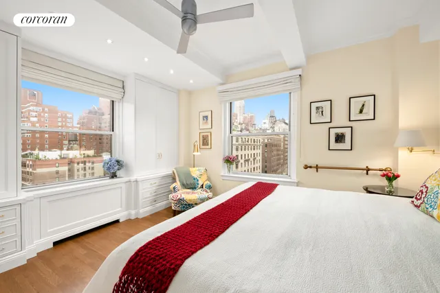 a view of a dining room with furniture one side kitchen view and wooden floor