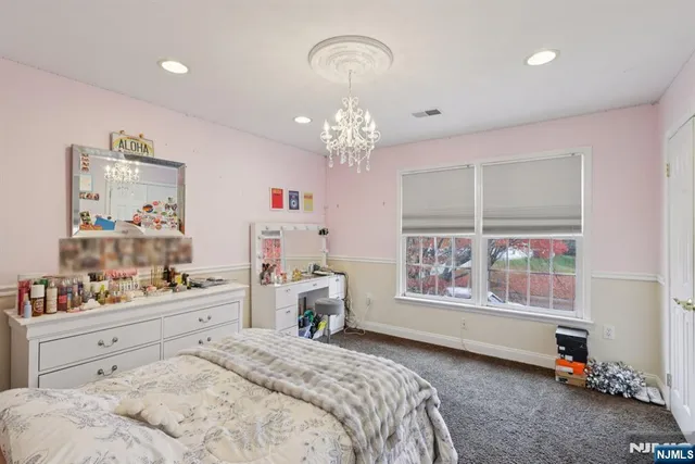 a bedroom with a bed and chandelier