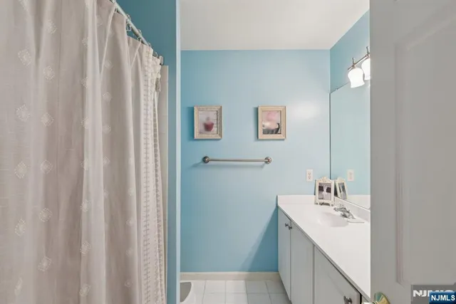 a bedroom with a bed and large windows