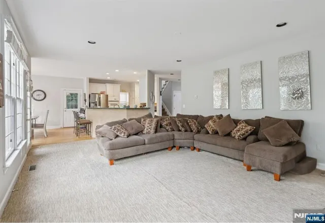 a living room with furniture and a large window