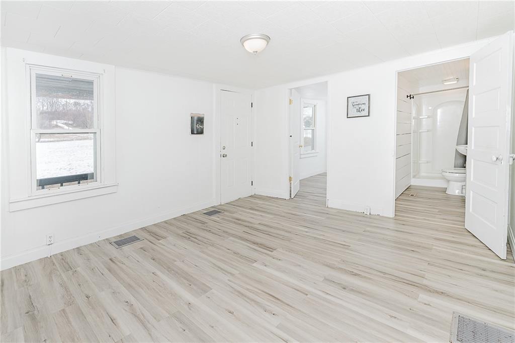 336 Walkchalk Road Kittanning, PA 16201 - Photo 12 of 49 a view of an empty room with wooden floor and a window