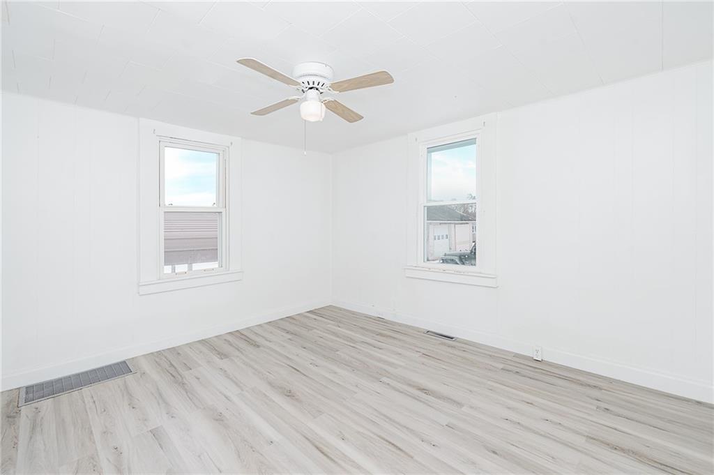 336 Walkchalk Road Kittanning, PA 16201 - Photo 17 of 49 a view of an empty room with wooden floor and a window