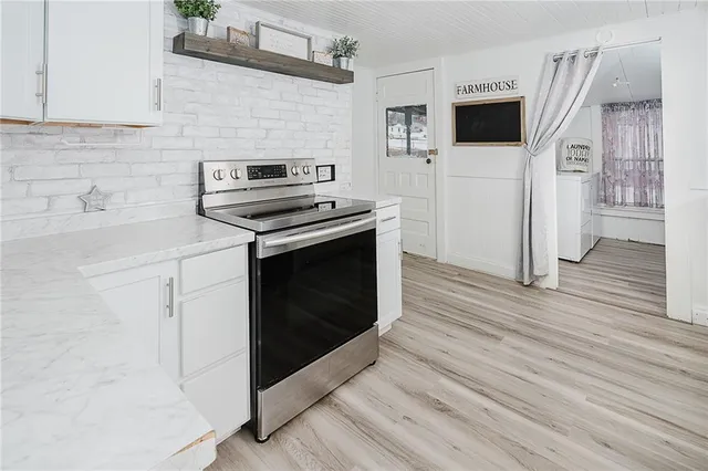a kitchen with cabinets and steel appliances