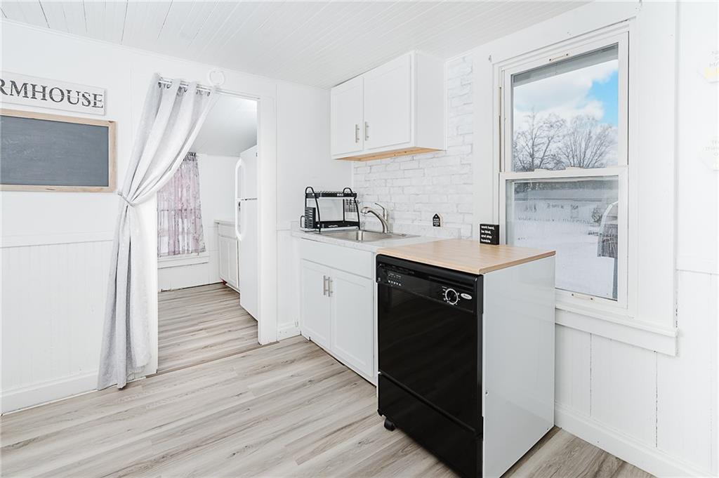336 Walkchalk Road Kittanning, PA 16201 - Photo 23 of 49 a kitchen with stainless steel appliances granite countertop a refrigerator a sink and white cabinets