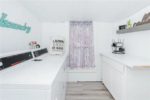 a room with a walk in closet and wooden floor