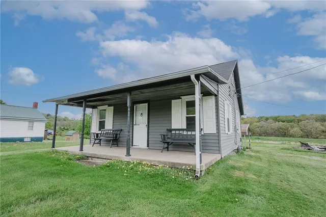 a view of an house with backyard space and a garden