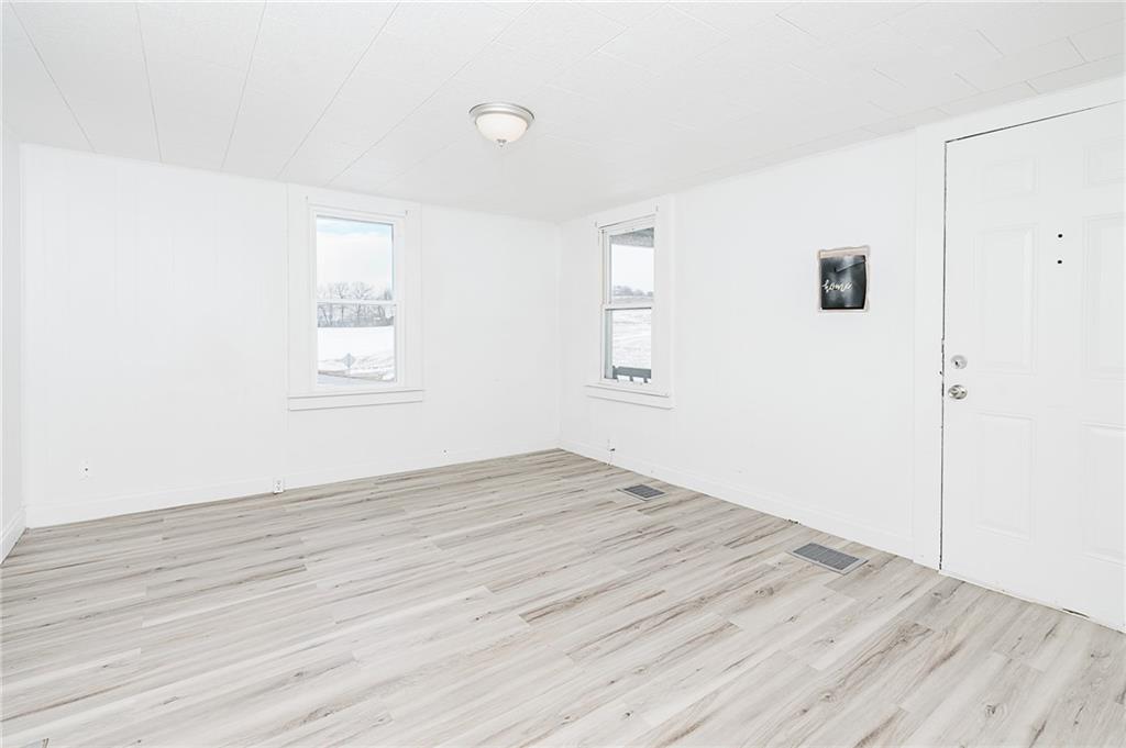 336 Walkchalk Road Kittanning, PA 16201 - Photo 10 of 49 an empty room with wooden floor and windows