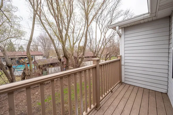 a view of wooden balcony and trees