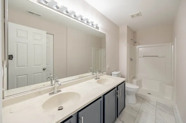 a bathroom with a sink double vanity and a mirror