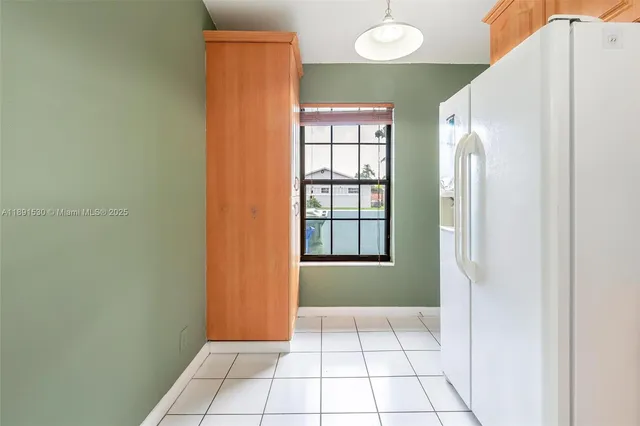 an empty room with windows and ceiling fan