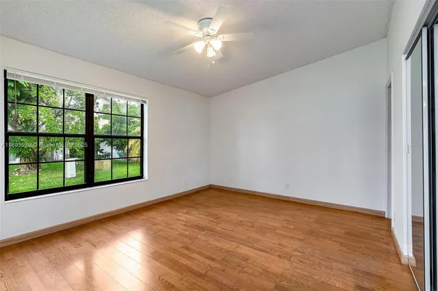 a bathroom with a sink a toilet a mirror and shower
