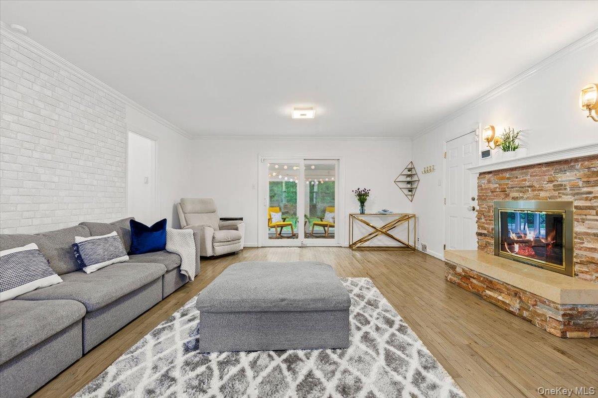 38 Brevoort Lane Rye, NY 10580 - Photo 13 of 42 Family room area with fireplace and access to enclosed sunroom.