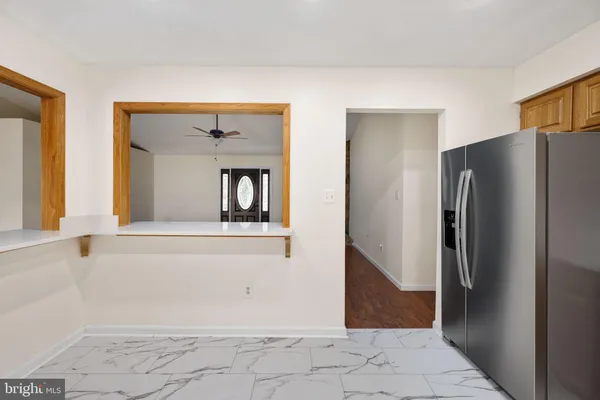 a bathroom with a granite countertop sink a toilet and shower