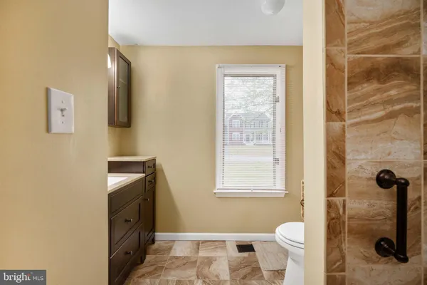 a white toilet sitting next to a shower curtain