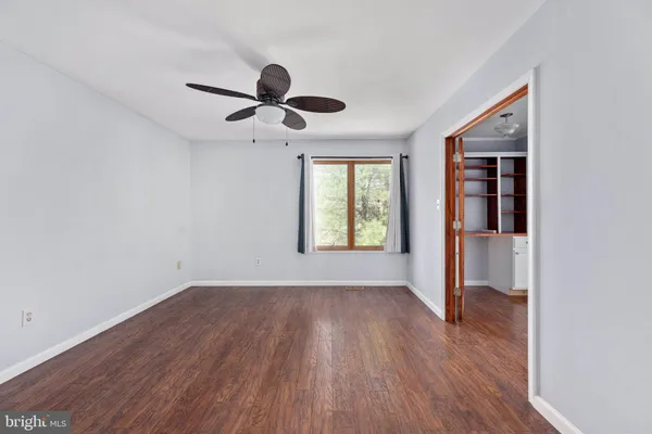 a kitchen with a refrigerator a stove cabinets and wooden floor