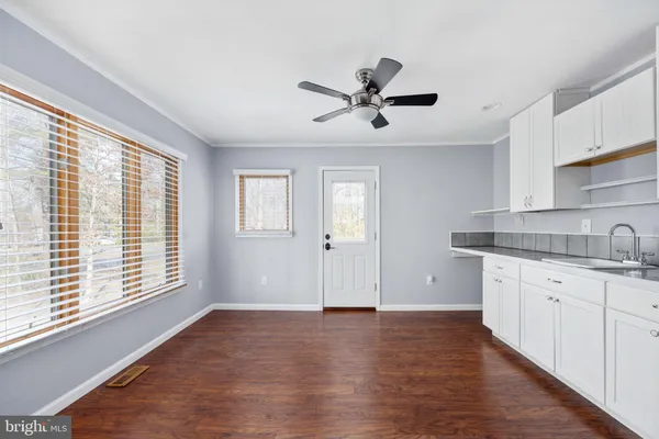 a view of balcony with wooden floor and seating