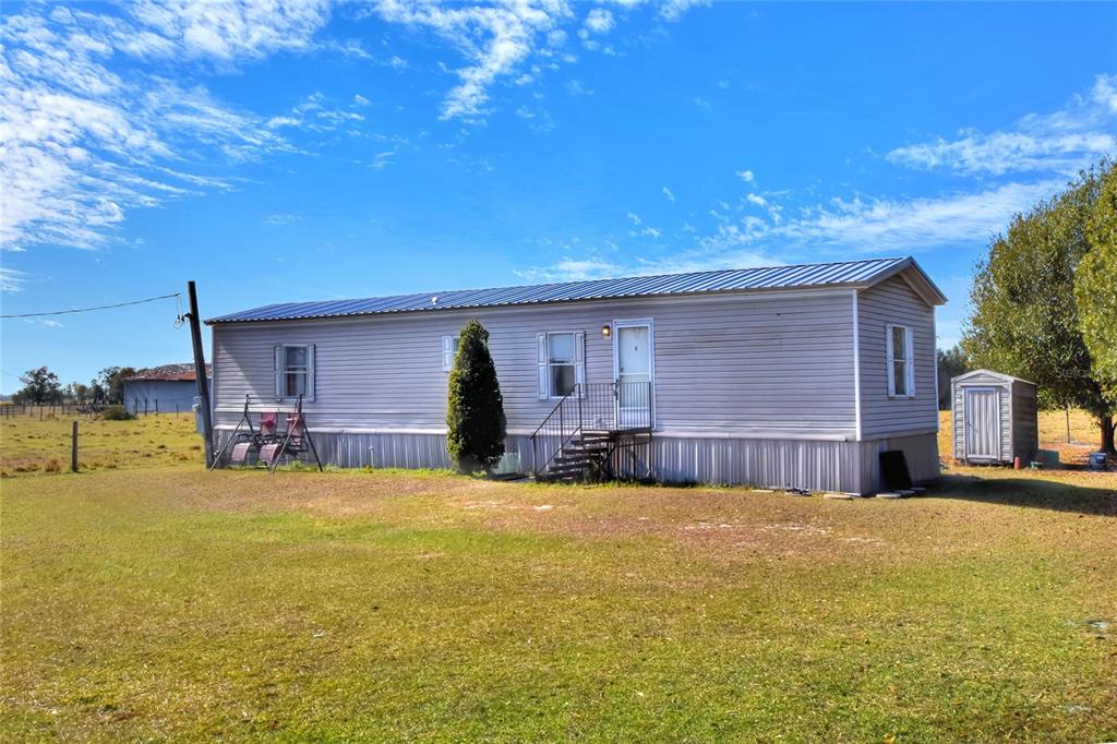 15901 Carlton Lake Road Wimauma, FL 33598 - Photo 2 of 5 a view of a house with swimming pool and a yard