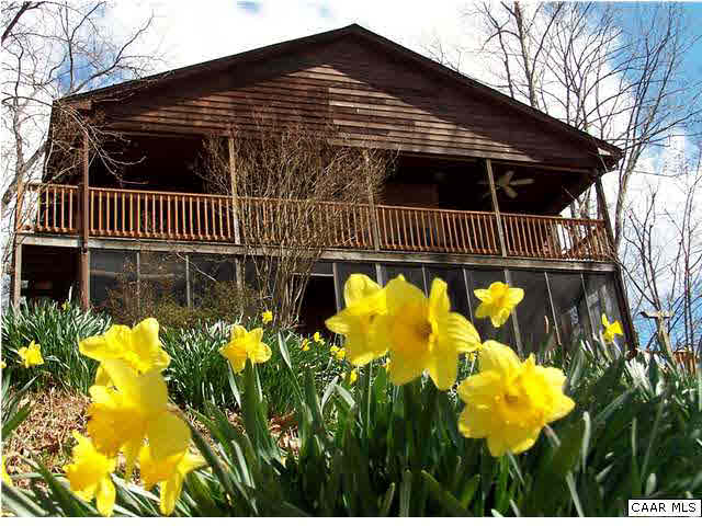540 Jonquil Road Ruckersville, VA 22968 - Photo 1 of 32 a front view of a house with a lot of flower and trees