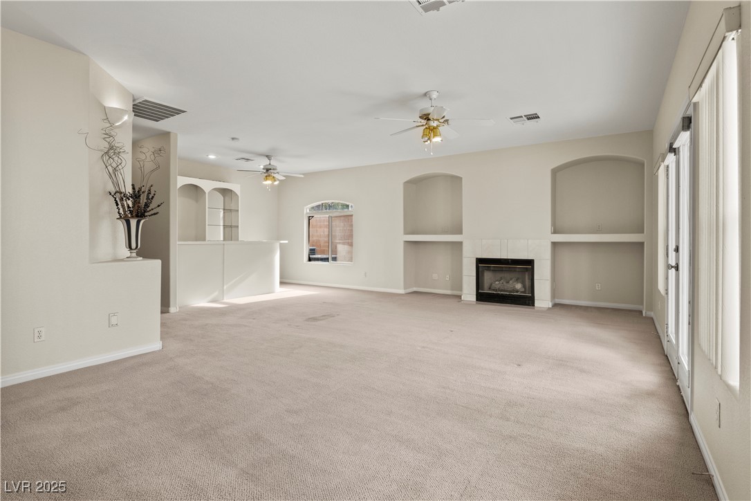 2576 Mizzoni Circle Henderson, NV 89052 - Photo 14 of 44 Large family room has a built-in bar, fireplace and French doors to the backyard.