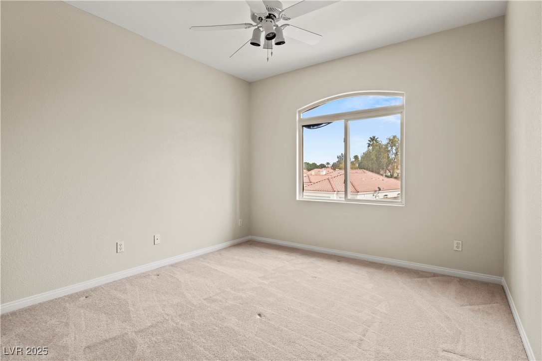 2576 Mizzoni Circle Henderson, NV 89052 - Photo 31 of 44 Bedroom 2 has a ceiling fan and walk-in closet.