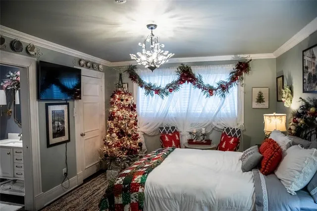 a bed room with a bed mirror and a window