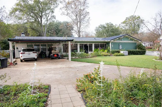 a car parked in front of house with a yard