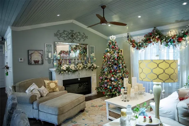 a living room with furniture a chandelier and a fireplace