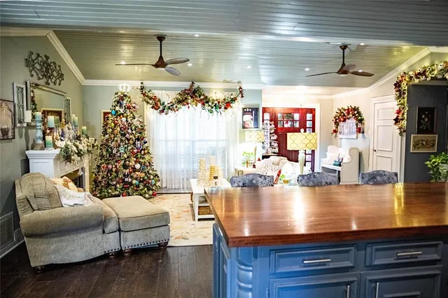 a living room with furniture and a chandelier