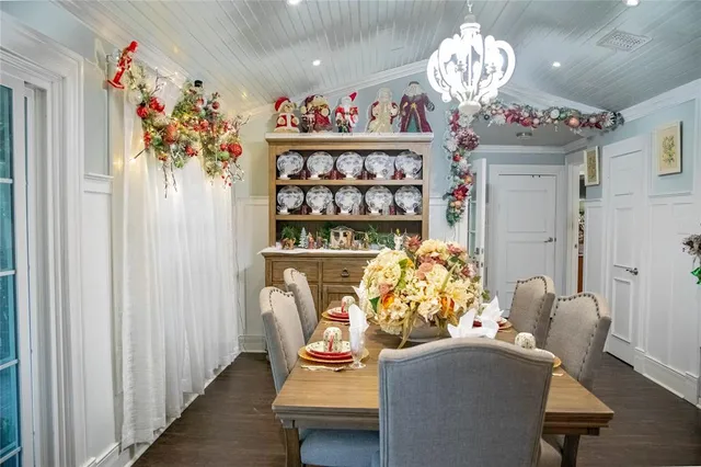 a view of a dining room with furniture and chandelier