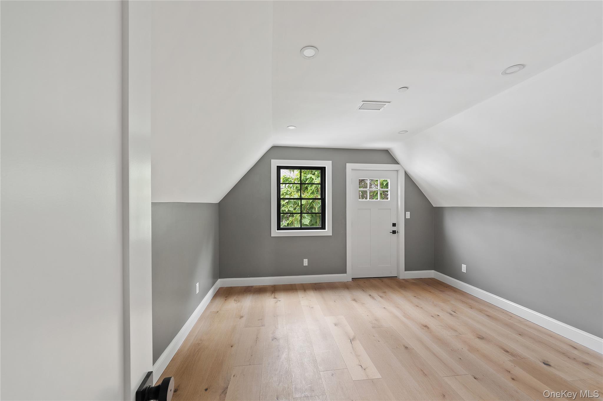 356 South 10th Avenue Mount Vernon, NY 10550 - Photo 15 of 30 an empty room with wooden floor and windows