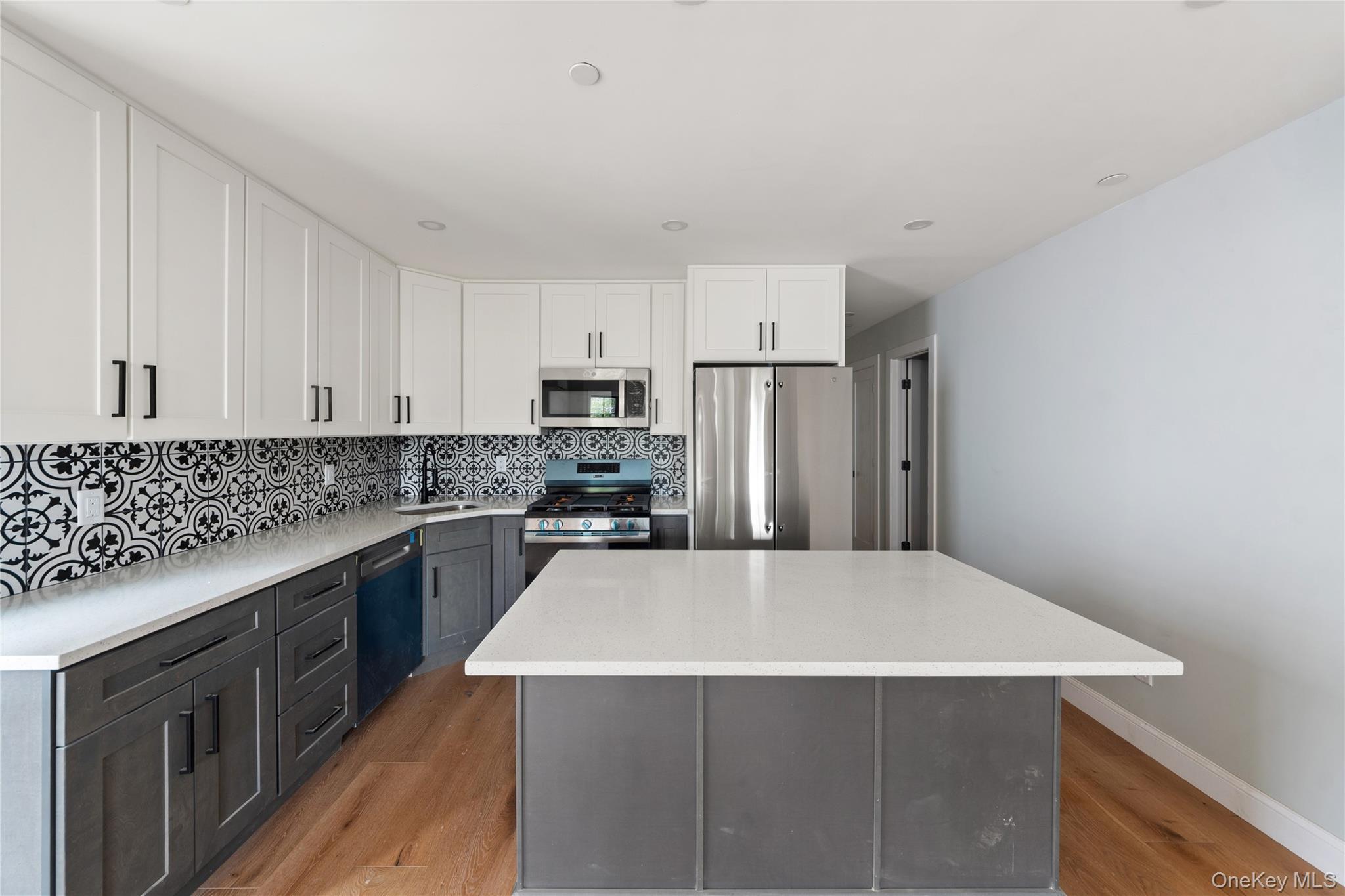 356 South 10th Avenue Mount Vernon, NY 10550 - Photo 2 of 30 a kitchen with stainless steel appliances a refrigerator and a stove top oven