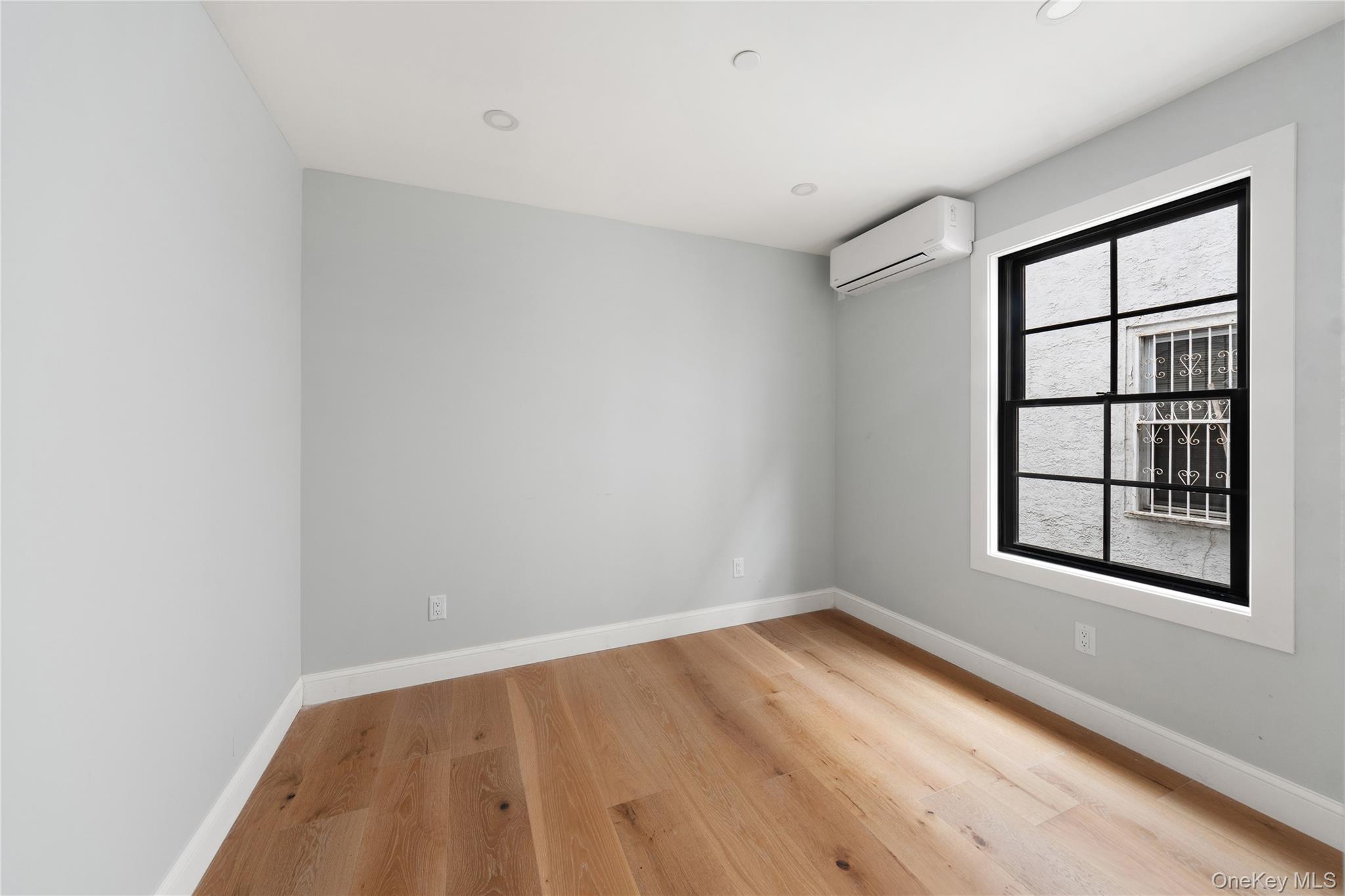 356 South 10th Avenue Mount Vernon, NY 10550 - Photo 22 of 30 an empty room with wooden floor and windows