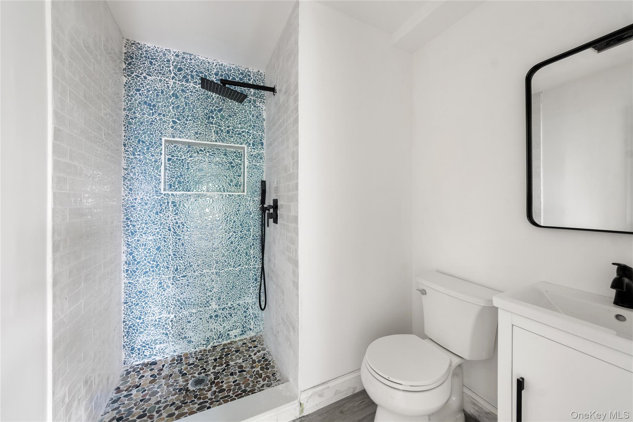 356 South 10th Avenue Mount Vernon, NY 10550 - Photo 24 of 30 a white toilet sitting next to a bathroom sink