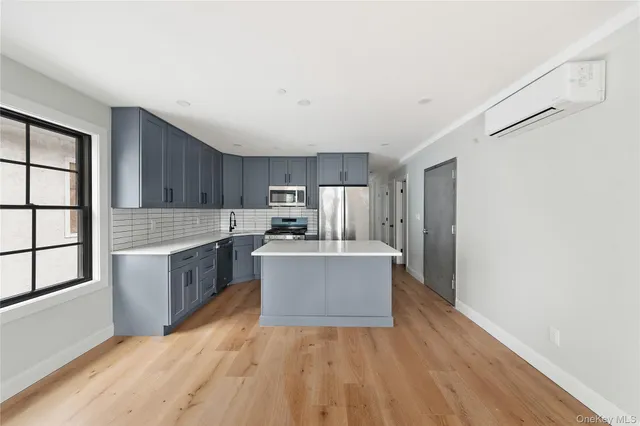 a view of kitchen with sink and wooden floor