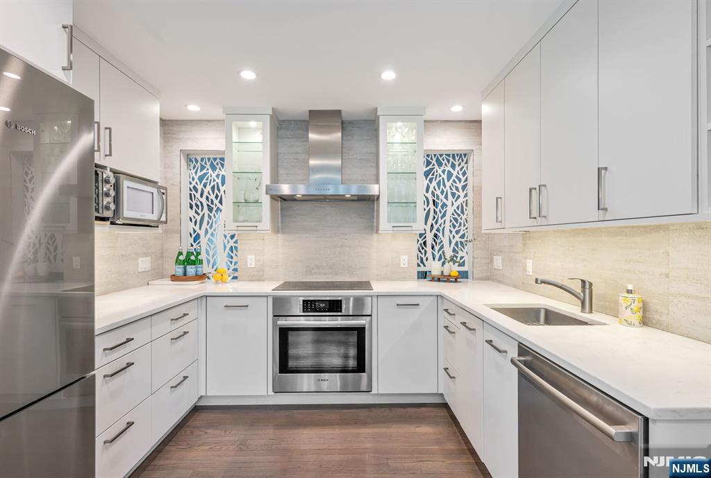 44 Deerfield Terrace Mahwah, NJ 07430 - Photo 18 of 42 a kitchen with white cabinets stainless steel appliances and sink