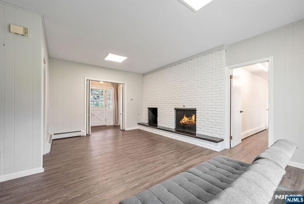 44 Deerfield Terrace Mahwah, NJ 07430 - Photo 19 of 42 a view of a livingroom with wooden floor and a fireplace
