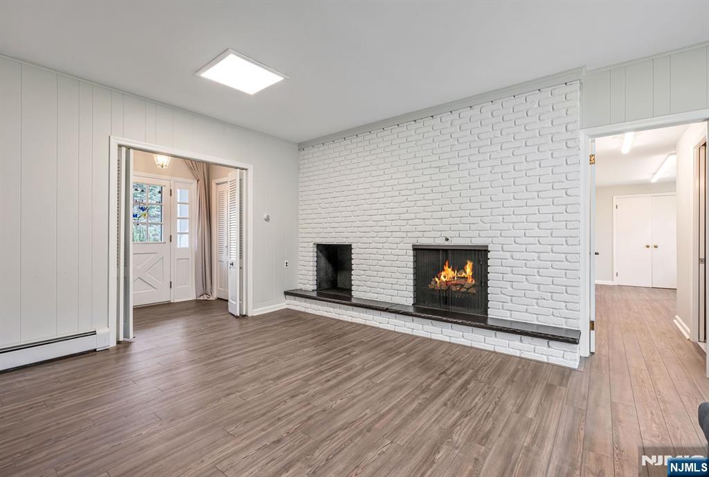 44 Deerfield Terrace Mahwah, NJ 07430 - Photo 20 of 42 an empty room with wooden floor and fireplace