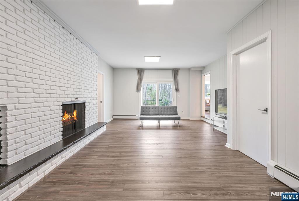 44 Deerfield Terrace Mahwah, NJ 07430 - Photo 21 of 42 a view of a livingroom with wooden floor and a fireplace