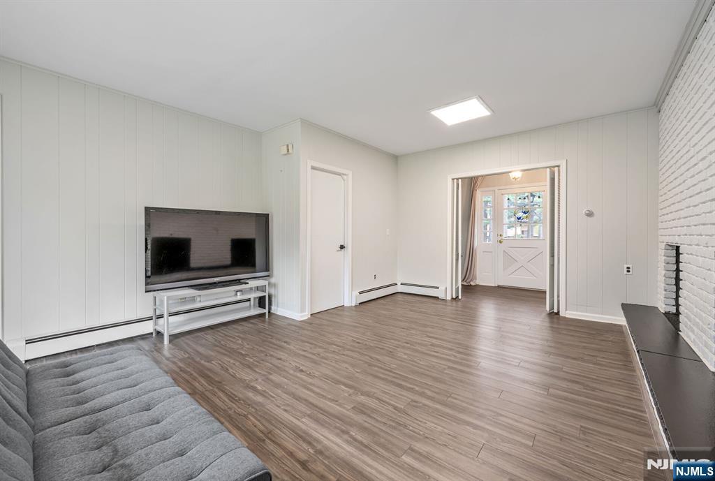 44 Deerfield Terrace Mahwah, NJ 07430 - Photo 22 of 42 a view of a livingroom with wooden floor and a flat screen tv