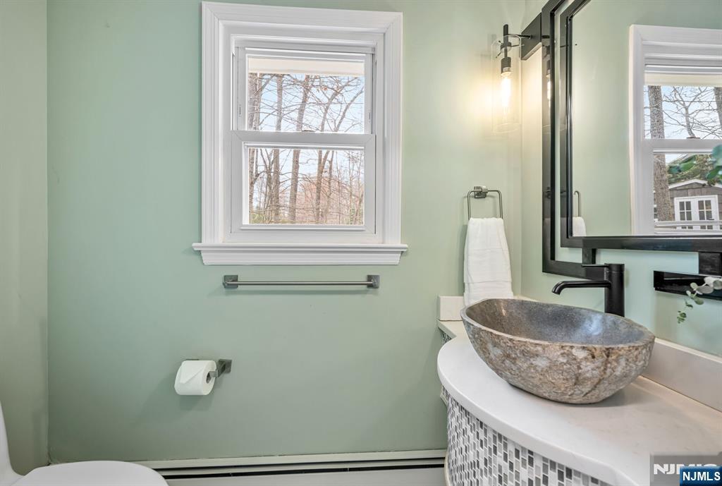44 Deerfield Terrace Mahwah, NJ 07430 - Photo 24 of 42 a room with a granite countertop toilet and a sink