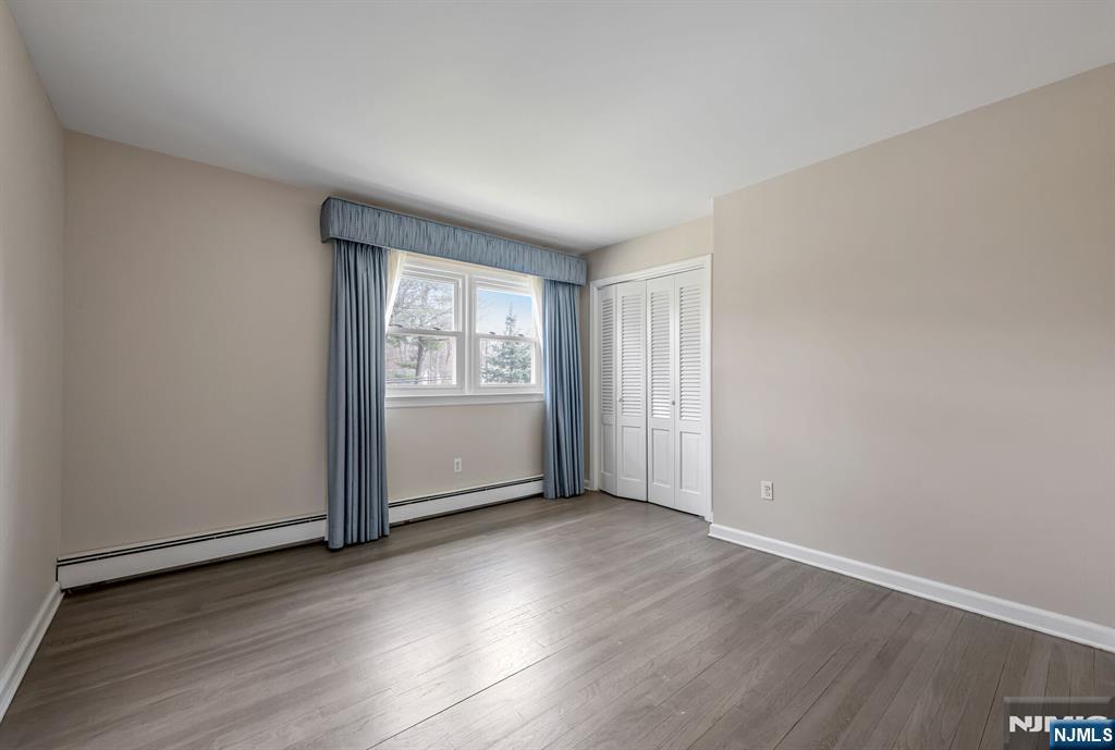 44 Deerfield Terrace Mahwah, NJ 07430 - Photo 32 of 42 an empty room with wooden floor and windows