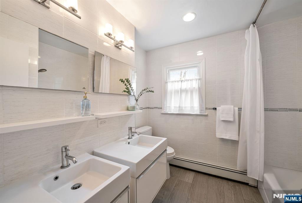 44 Deerfield Terrace Mahwah, NJ 07430 - Photo 33 of 42 a bathroom with a sink a mirror and vanity