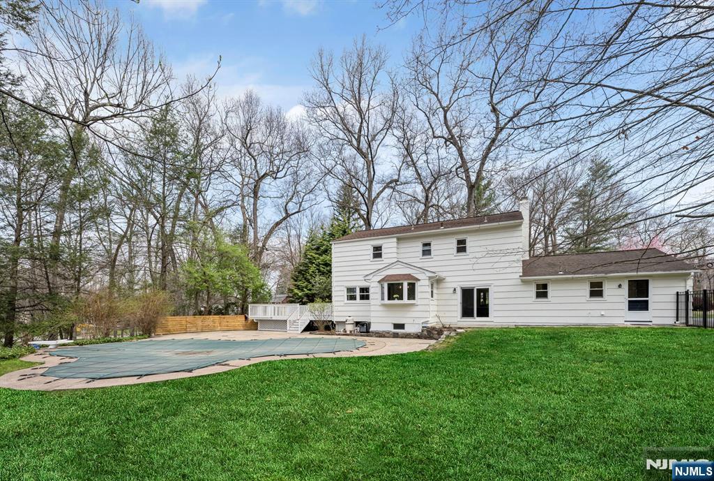 44 Deerfield Terrace Mahwah, NJ 07430 - Photo 37 of 42 a white house with a white bed in front of a house