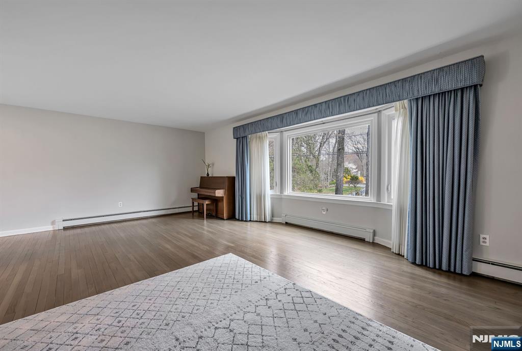 44 Deerfield Terrace Mahwah, NJ 07430 - Photo 7 of 42 a view of an empty room with a window and wooden floor