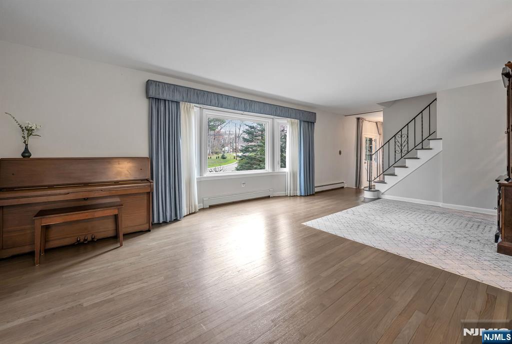 44 Deerfield Terrace Mahwah, NJ 07430 - Photo 8 of 42 a view of an empty room with wooden floor and a window