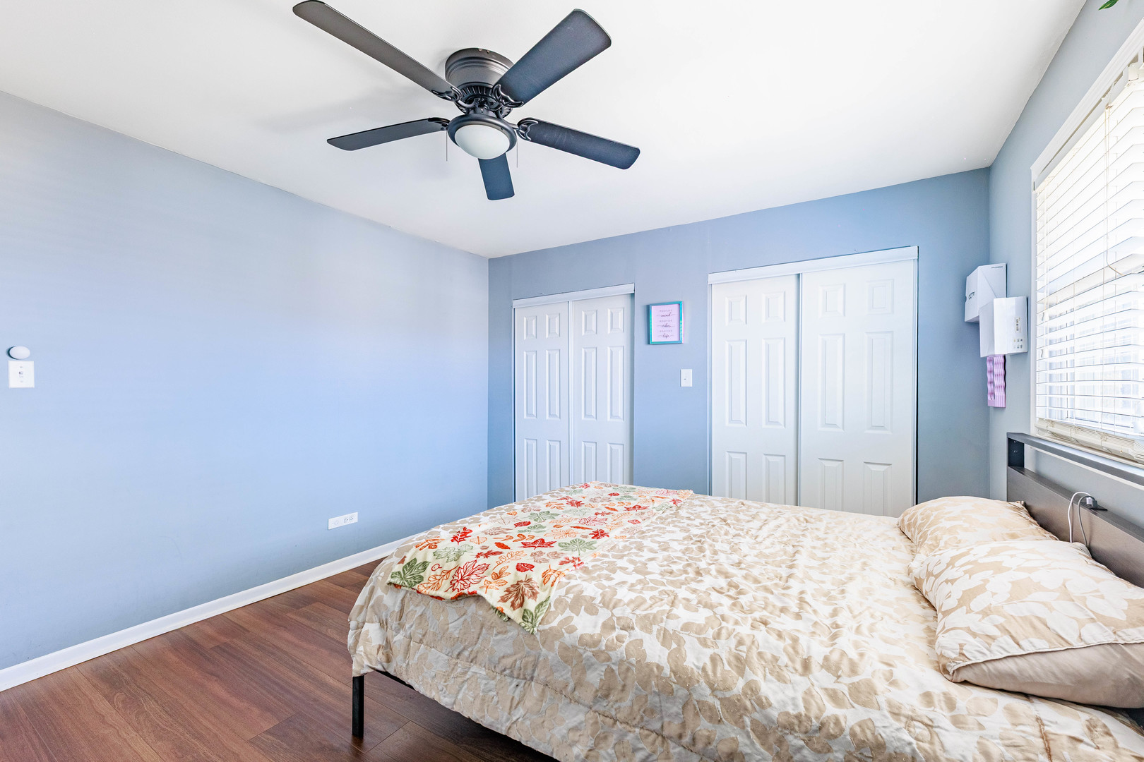 11036 Kilpatrick Avenue, Unit 3SW Oak Lawn, IL 60453 - Photo 16 of 19 a bedroom with a bed and a ceiling fan